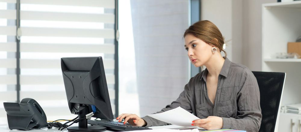 Accountant reviewing financial documents at her desk